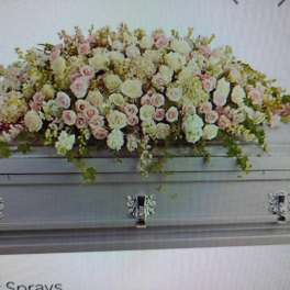 Large pastel floral casket spray with pink and white blooms