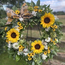 Sunflower wreath with white flowers and a burlap bow