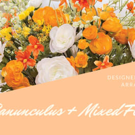 Orange and white mixed flower arrangement with daisies and ranunculus