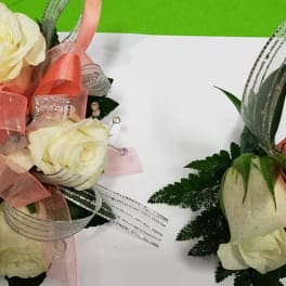 White rose corsage and matching boutonniere with pink and silver ribbon accents