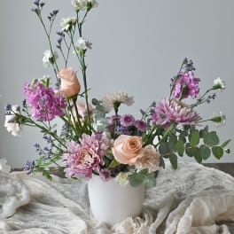 Pink and white mixed bouquet in a white vase