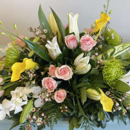 Mixed bouquet with pink roses, white lilies, and yellow calla lilies