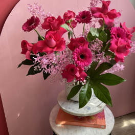 Pink rose and gerbera daisy arrangement in a white vase