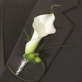 White calla lily boutonniere with green berries on a black suit jacket
