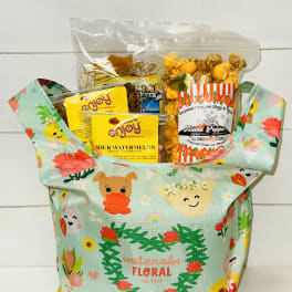 Gift tote filled with assorted packaged snacks and popcorn