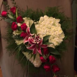 Heart-shaped floral arrangement with red roses and white chrysanthemums