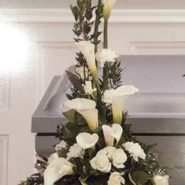 Tall white calla lily and rose arrangement in a vase