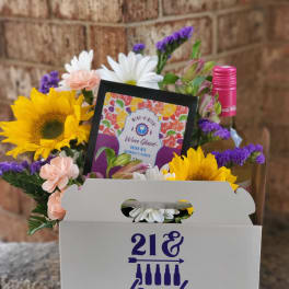Flower gift box with sunflowers, daisies, carnations, and a wine mix packet