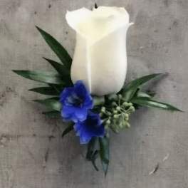 White calla lily boutonniere with blue flowers