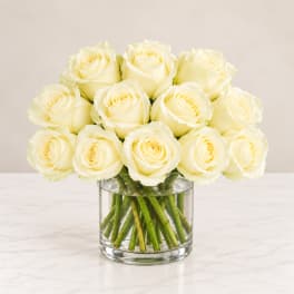 Bouquet of cream white roses in a clear glass vase