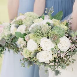 White rose and succulent bouquet with soft pink accents