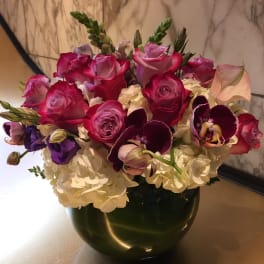 Pink and purple mixed bouquet in a dark vase