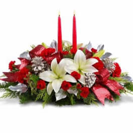 Red and white floral centerpiece with two red candles