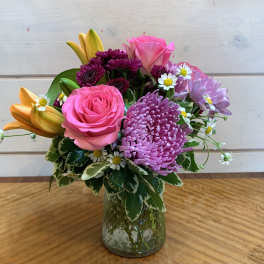 Pink and purple mixed bouquet in a glass vase