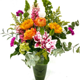 Colorful mixed flower arrangement in a green vase