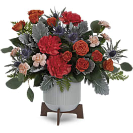 Bouquet of red and orange roses in a white vase