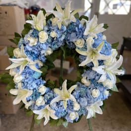 Blue hydrangea wreath with white lilies and small white roses