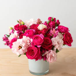 Pink and white rose bouquet in a clear glass vase