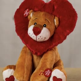 Plush teddy bear holding a red heart