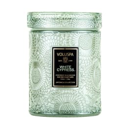 Green glass candle jar with a lid and label