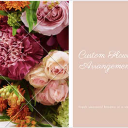 Pink and orange flower arrangement with roses and carnations