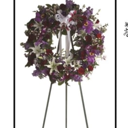Purple and white floral wreath on a standing easel