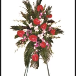Standing floral spray with red anthuriums and pink accents