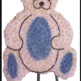 Teddy bear-shaped floral tribute with blue and pale pink flowers