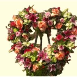 Heart-shaped floral wreath with pink, orange, and purple flowers