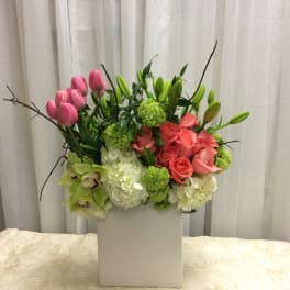 Pink tulips and roses in a white box with green accents