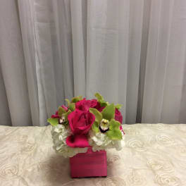 Pink rose and orchid arrangement in a square pink box