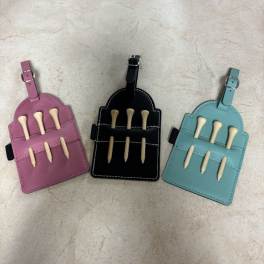Three small leather pouches with buckles and bone-shaped pieces