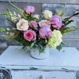 Pink and white roses with hydrangea in a white vase