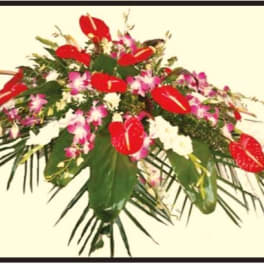 Tropical floral arrangement with red anthuriums and pink orchids