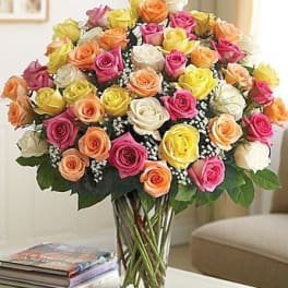 Bouquet of multicolored roses in a clear glass vase