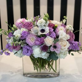 Lavender and white mixed bouquet in a clear glass vase