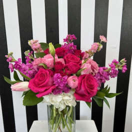 Pink and purple mixed bouquet in a clear glass vase