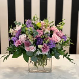 Pink and purple mixed bouquet in a clear glass vase