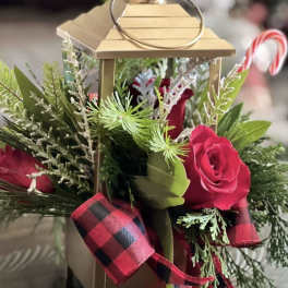 Gold lantern with red roses and holiday greenery
