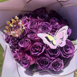 Bouquet of purple roses with a butterfly and crown topper