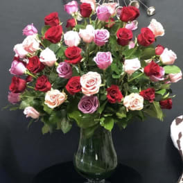 Mixed roses in a clear glass vase