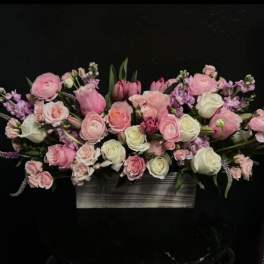 Pink and white floral arrangement in a rectangular wooden container