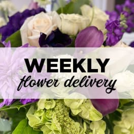 Purple and white floral arrangement with roses and hydrangeas