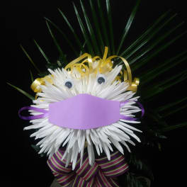 White chrysanthemum face with ribbon and palm fronds