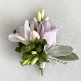 Small boutonniere with pale lavender and white flowers