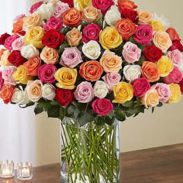 Large bouquet of multicolored roses in a clear glass vase
