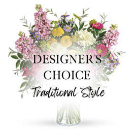 Mixed bouquet in a clear glass vase with pink, yellow, white, and purple flowers