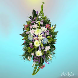 Tall mixed floral spray with lilies, roses, hydrangeas, and purple accents