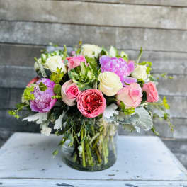 Mixed pink and white roses in a glass vase