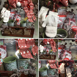 Christmas gift basket with mugs, candy, gloves, and ribbon